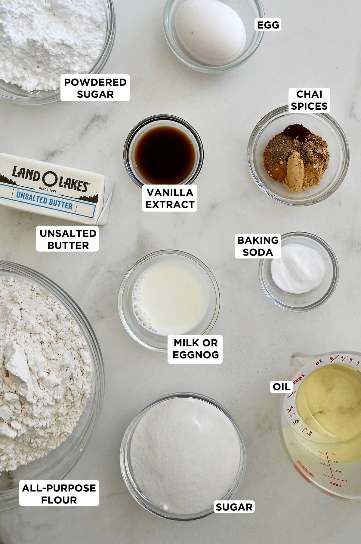 Various sizes of glass bowls containing the ingredients needed to make Taylor Swift's chai cookies with an eggnog icing.