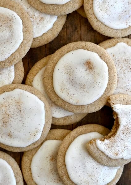 Taylor Swift chai cookies with eggnog icing piled atop each other with a bite taken out of one cookie.