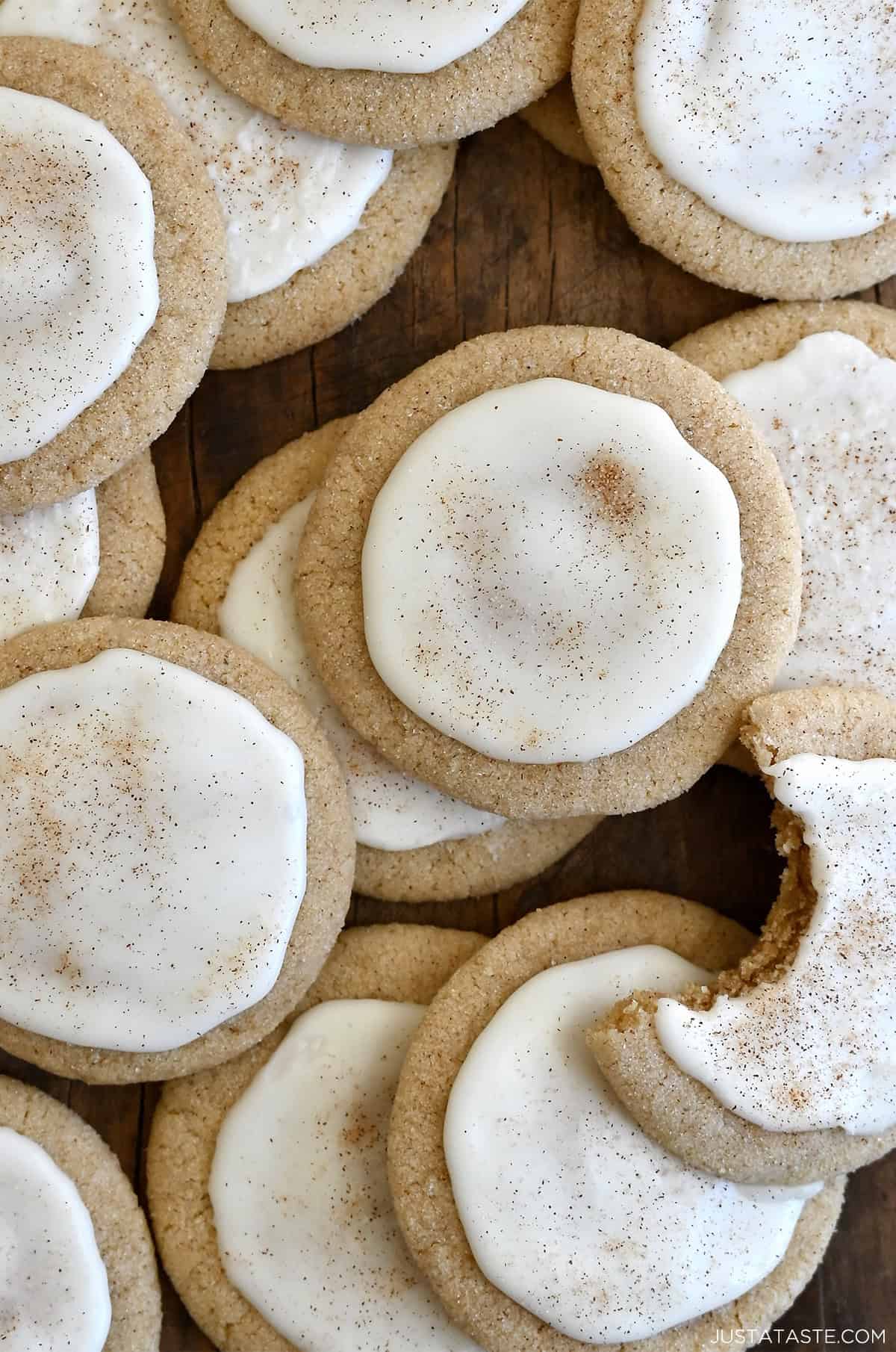Taylor Swift chai cookies with eggnog icing piled atop each other with a bite taken out of one cookie.