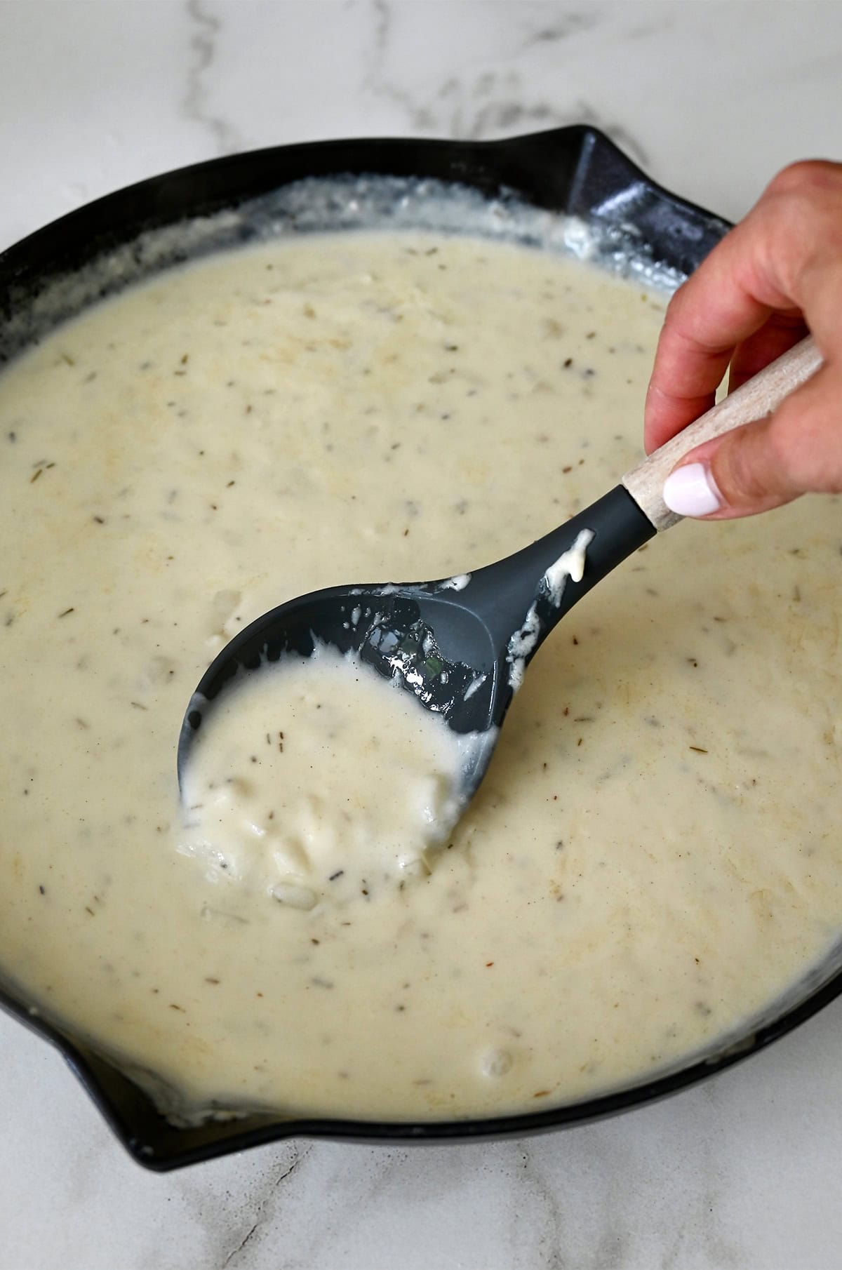 Thick and creamy pot pie sauce in a large oven-safe skillet.
