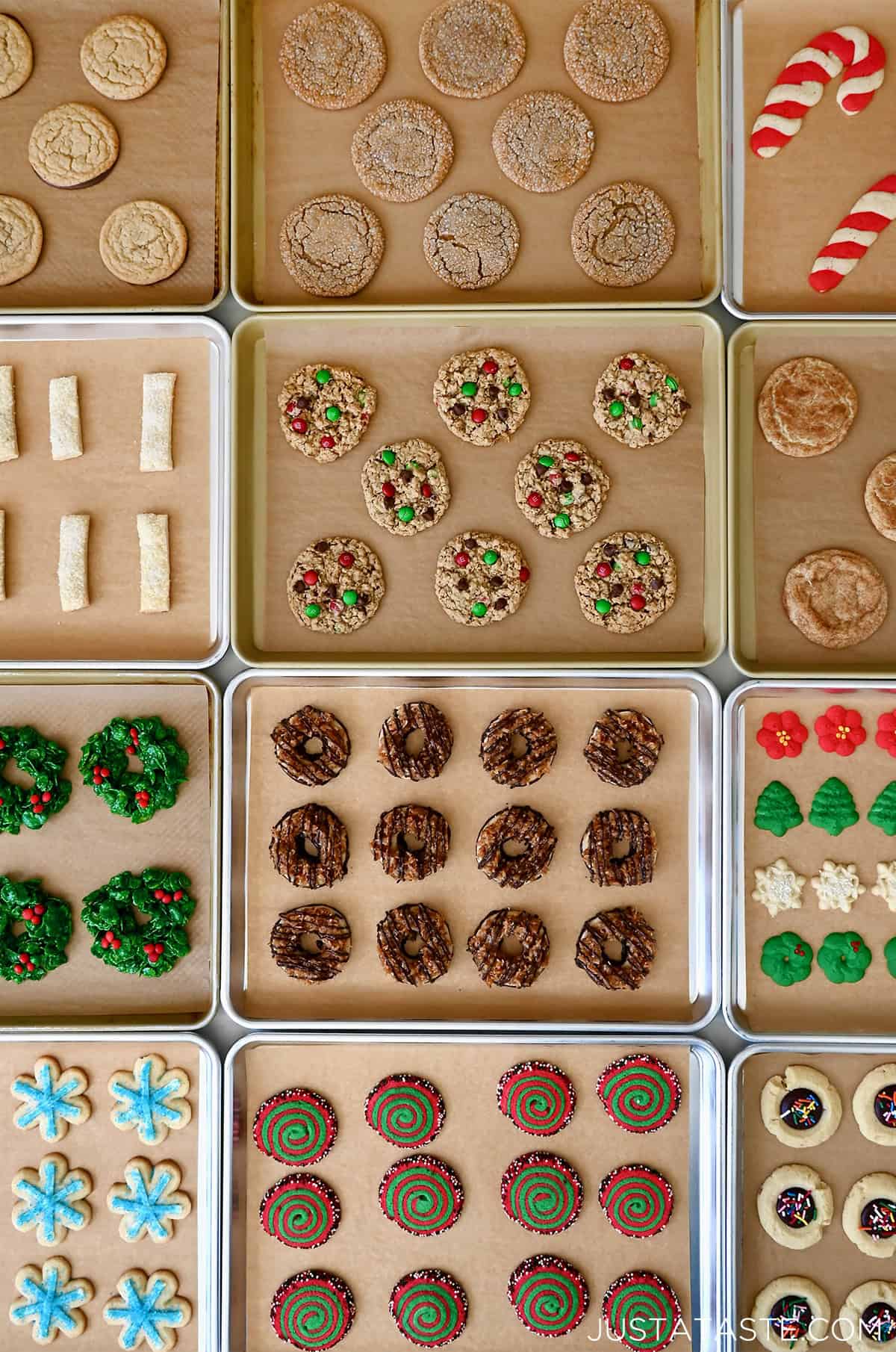 Twelve cookie sheets with twelve varieties of Christmas cookies.