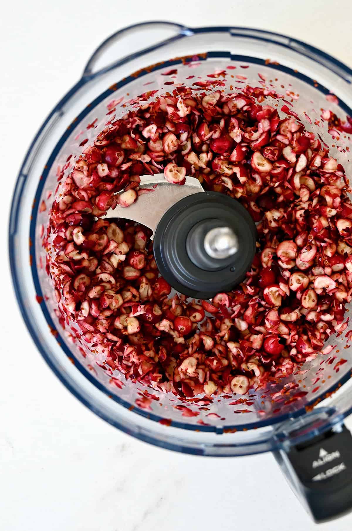 Roughly chopped cranberries in a food processor.