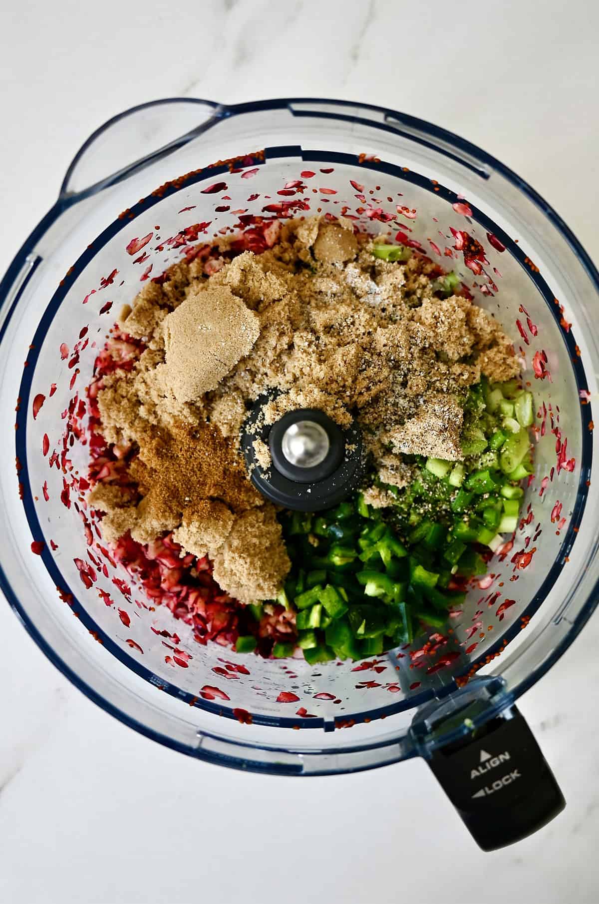 Brown sugar, chopped jalapeño, cumin, lime juice, lime zest and chopped scallions in a food processor with chopped cranberries.