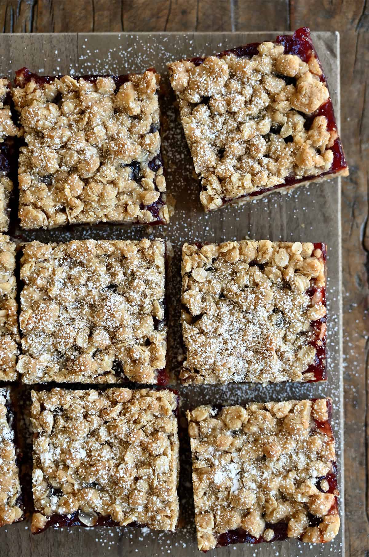 Cranberry crumb bars dusted with powdered sugar.