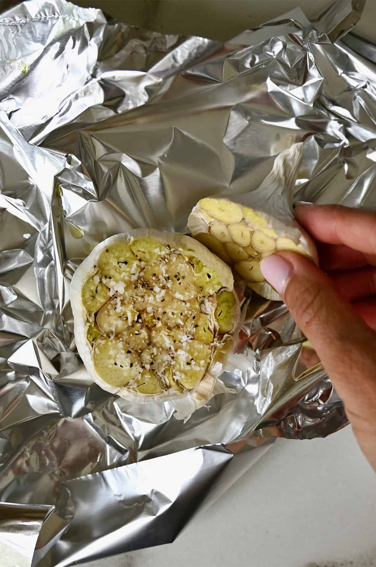 A head of garlic, cut in half, drizzled with olive oil and sprinkled with salt and pepper.