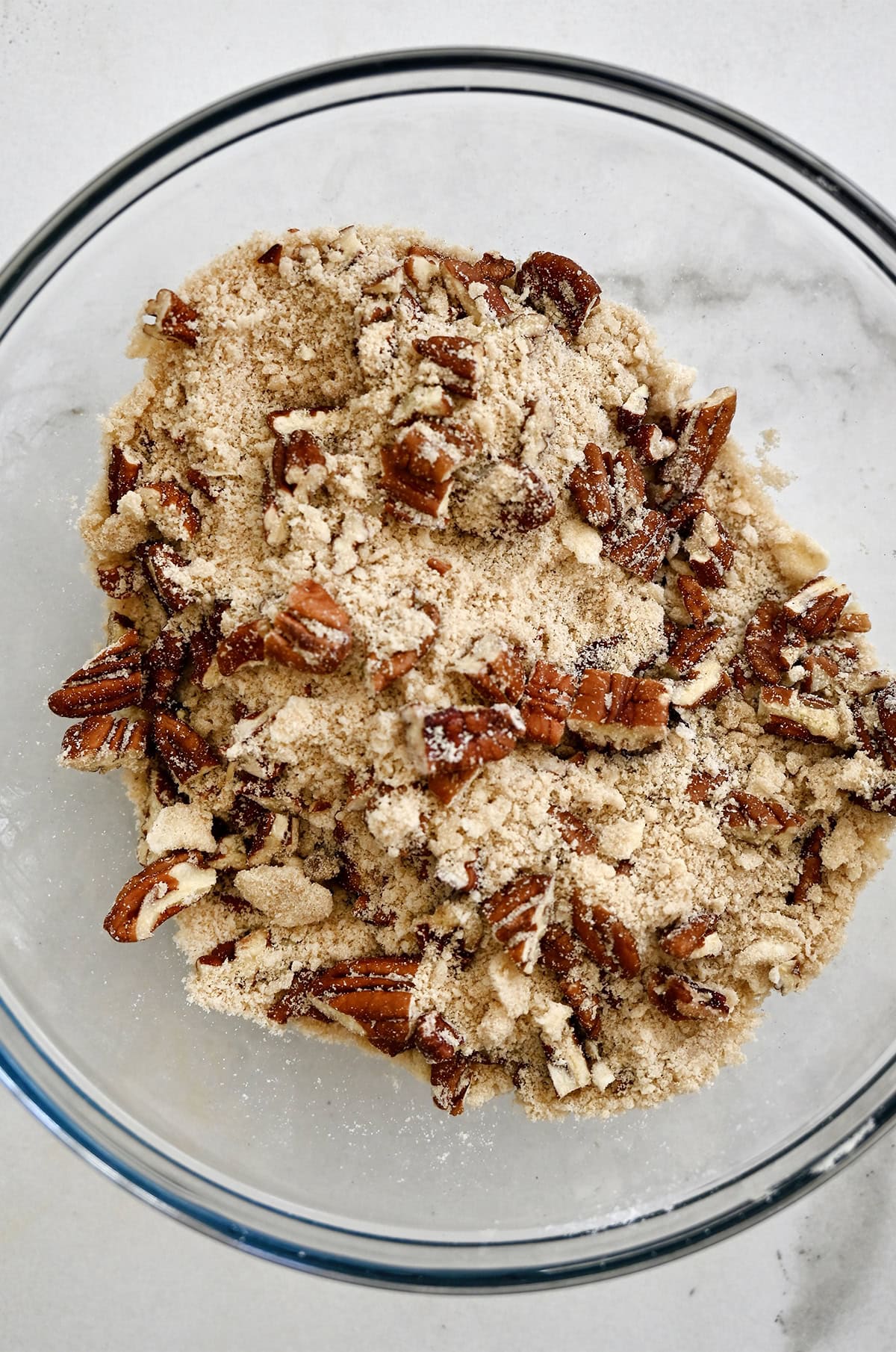 Pecan crumble for sweet potato casserole in a glass bowl.