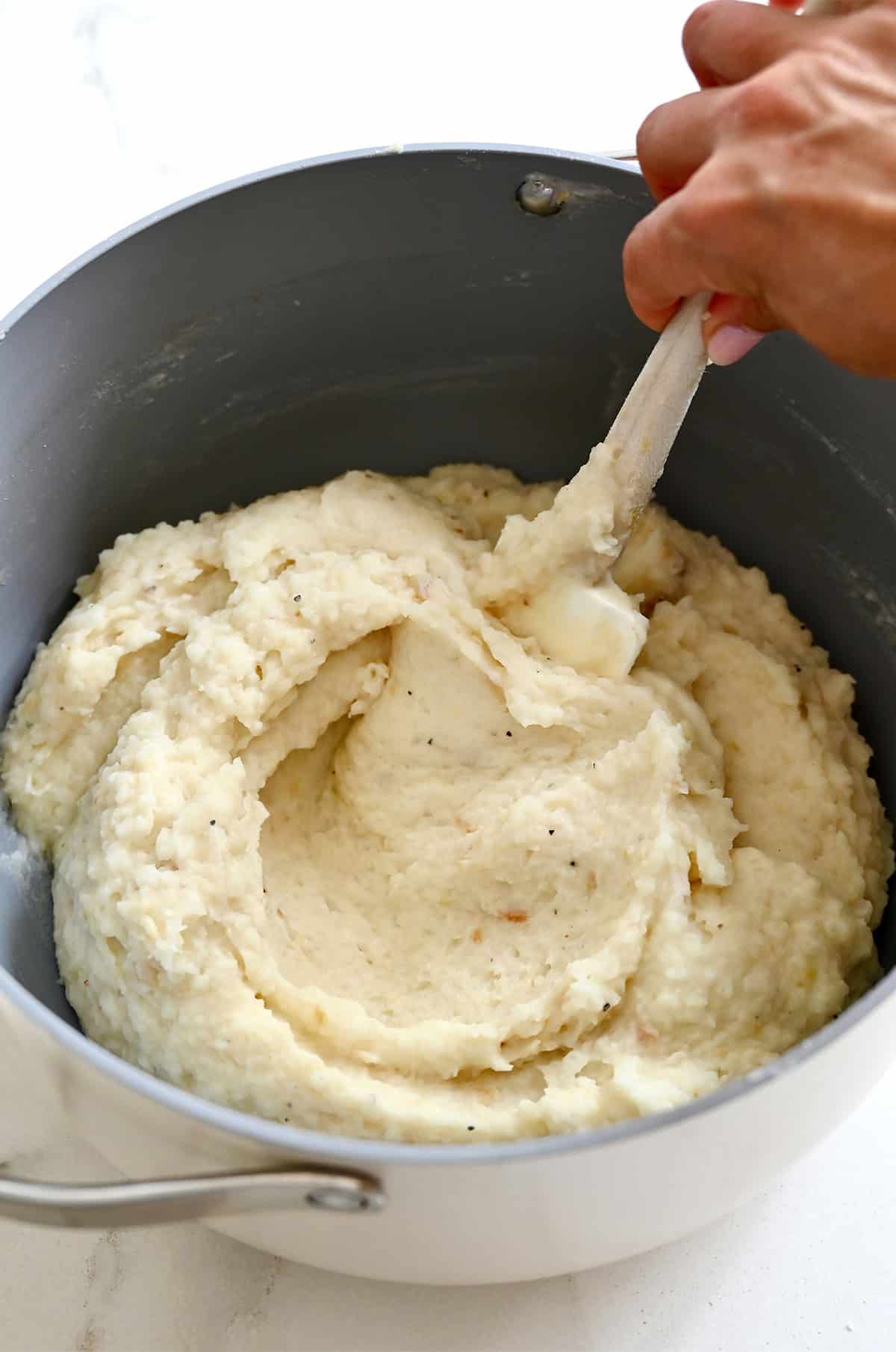 Creamy roasted garlic mashed potatoes in a pot.