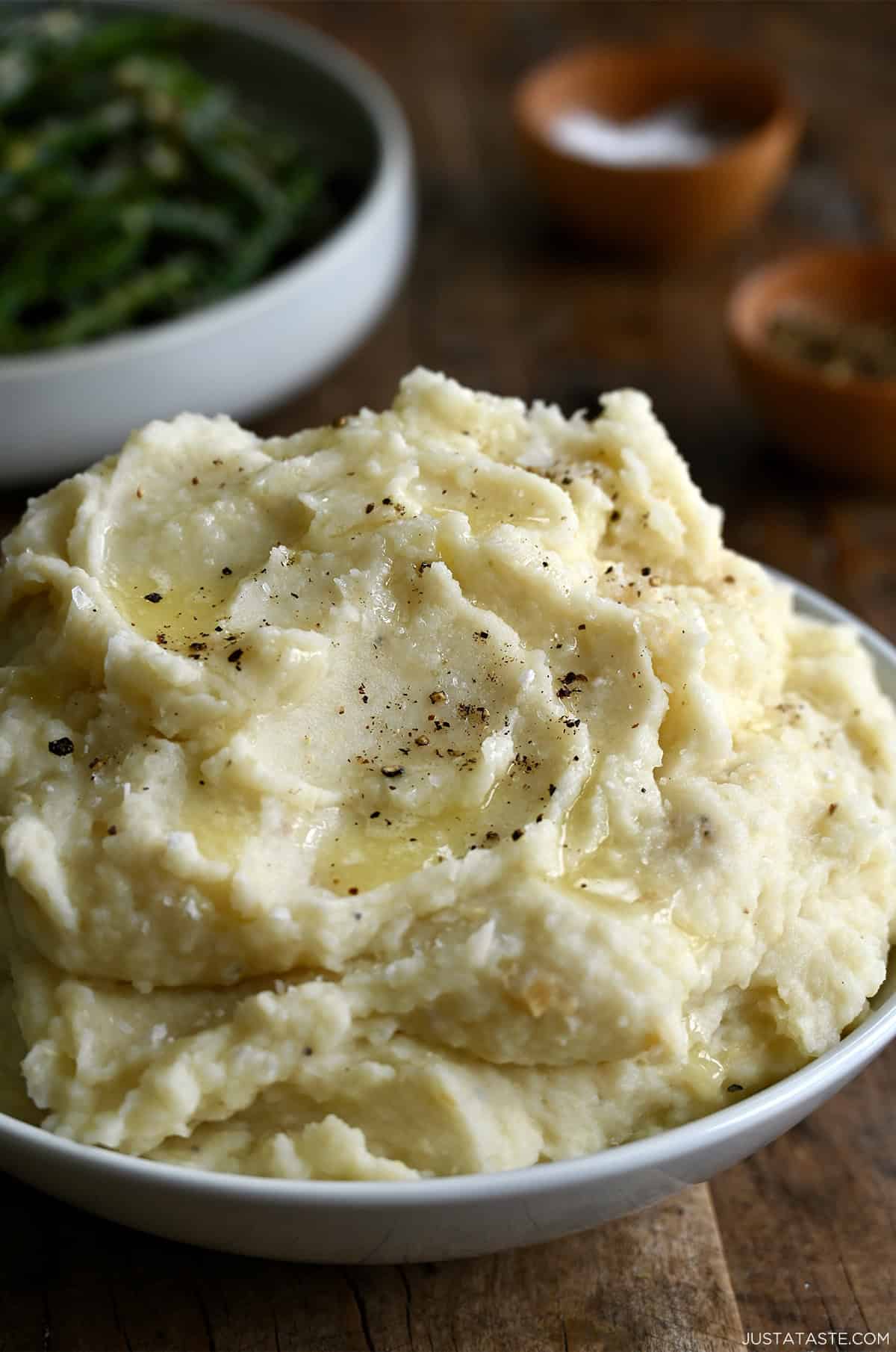 Roasted garlic mashed potatoes in a white serving bowl.