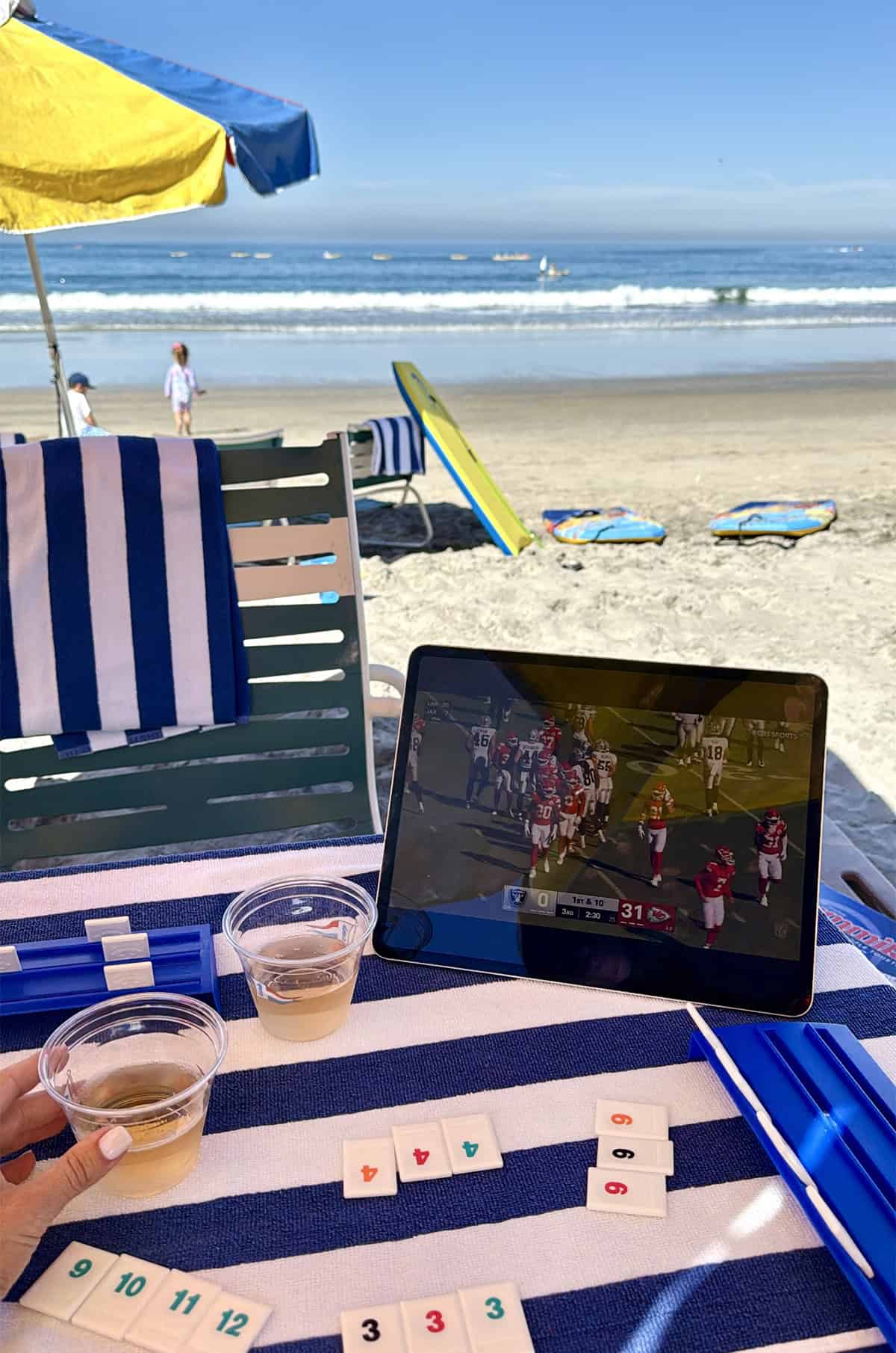 Beach setup with football and rummikub