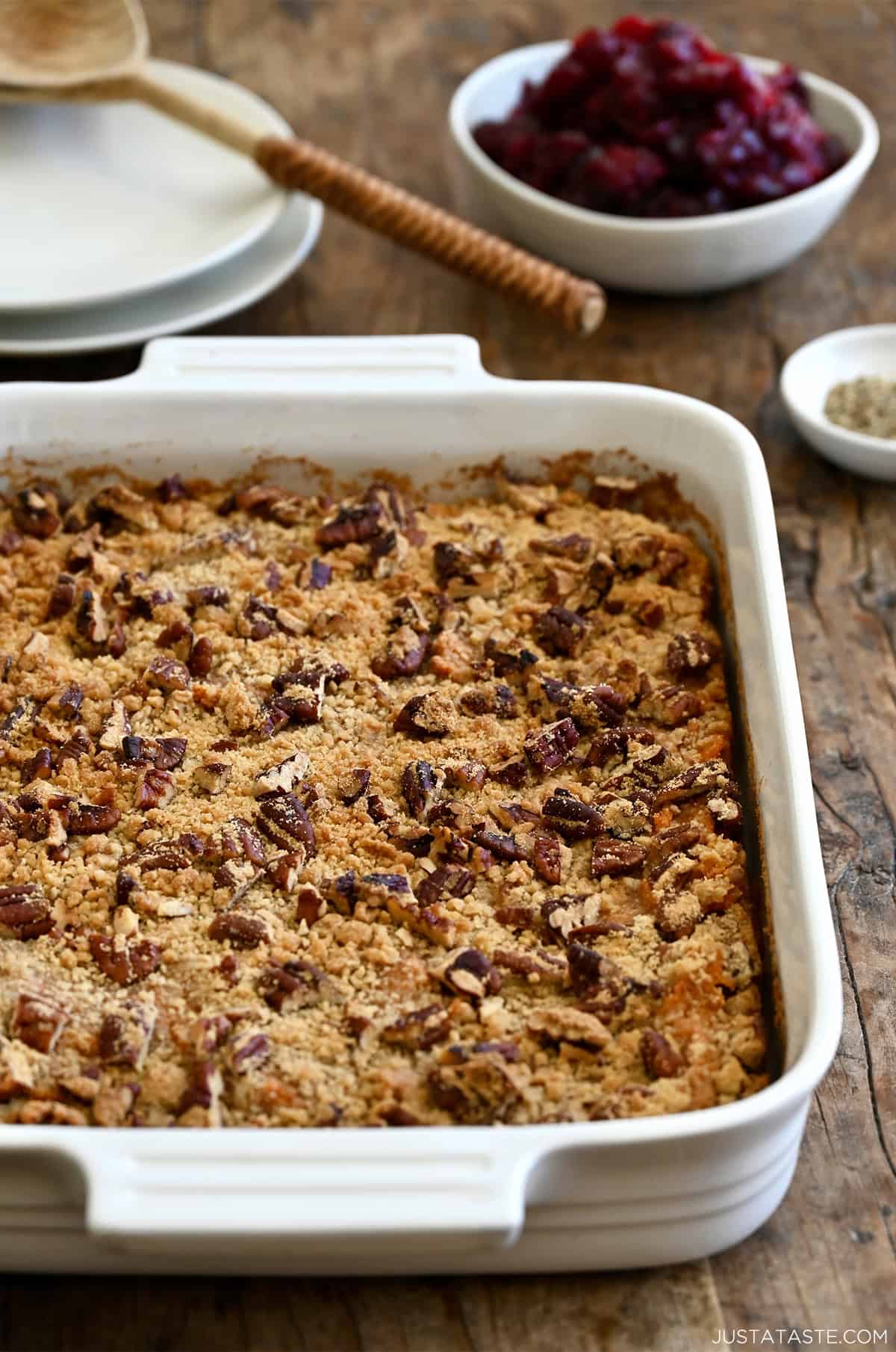 Golden sweet potato casserole fresh out of the oven with a crisp pecan topping.