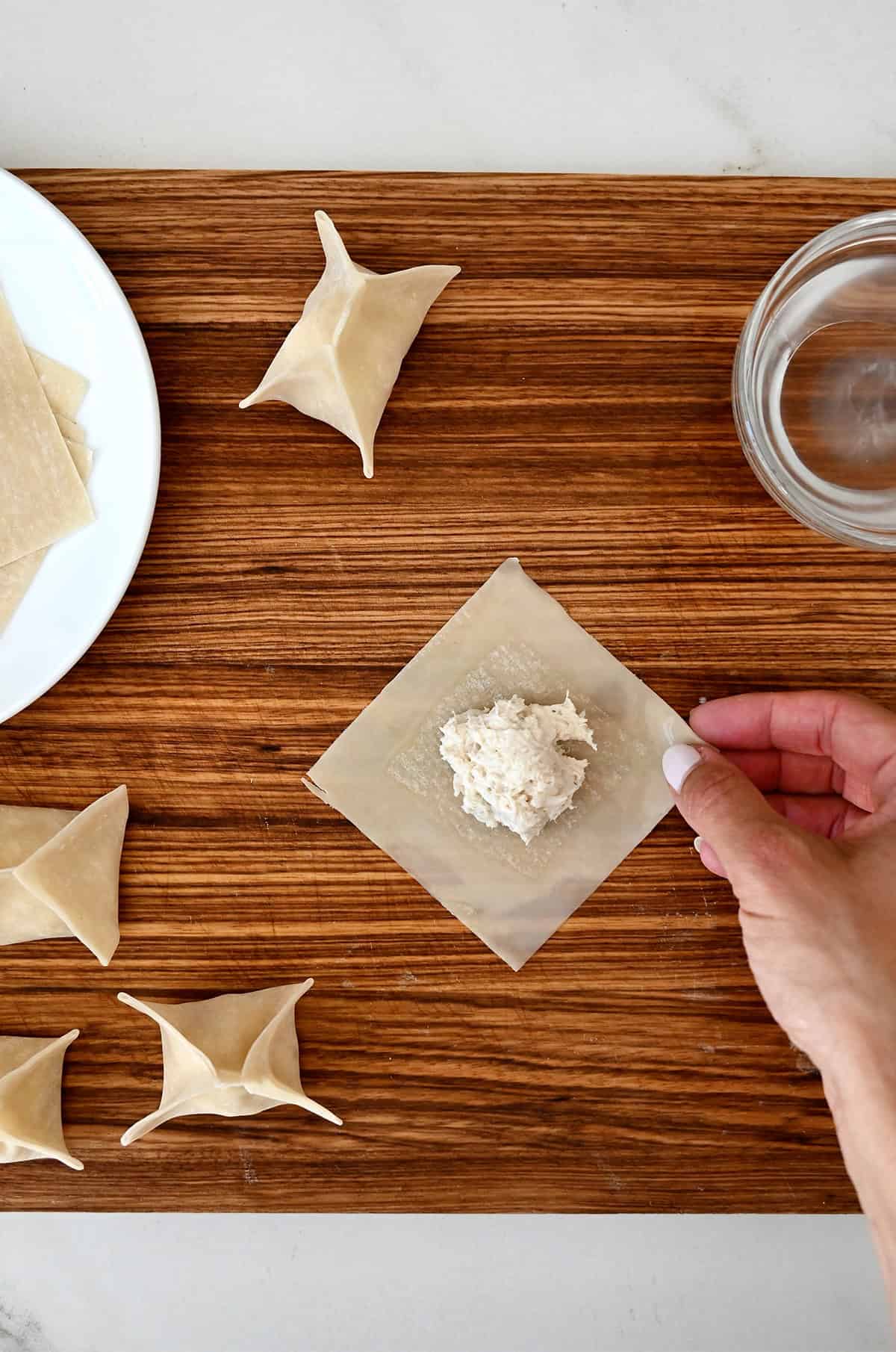 Crab filling in the center of a wonton wrapper.