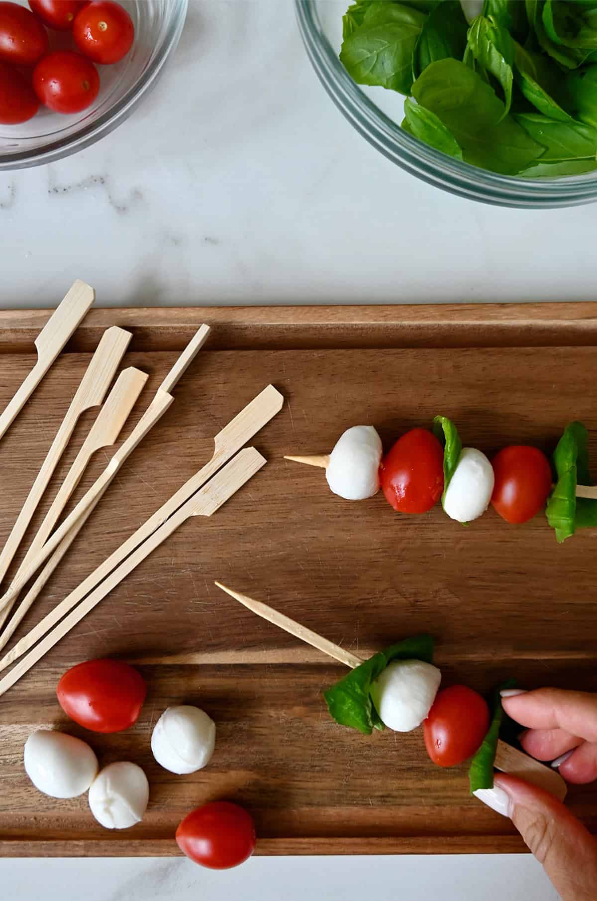 Assembling caprese skewers.