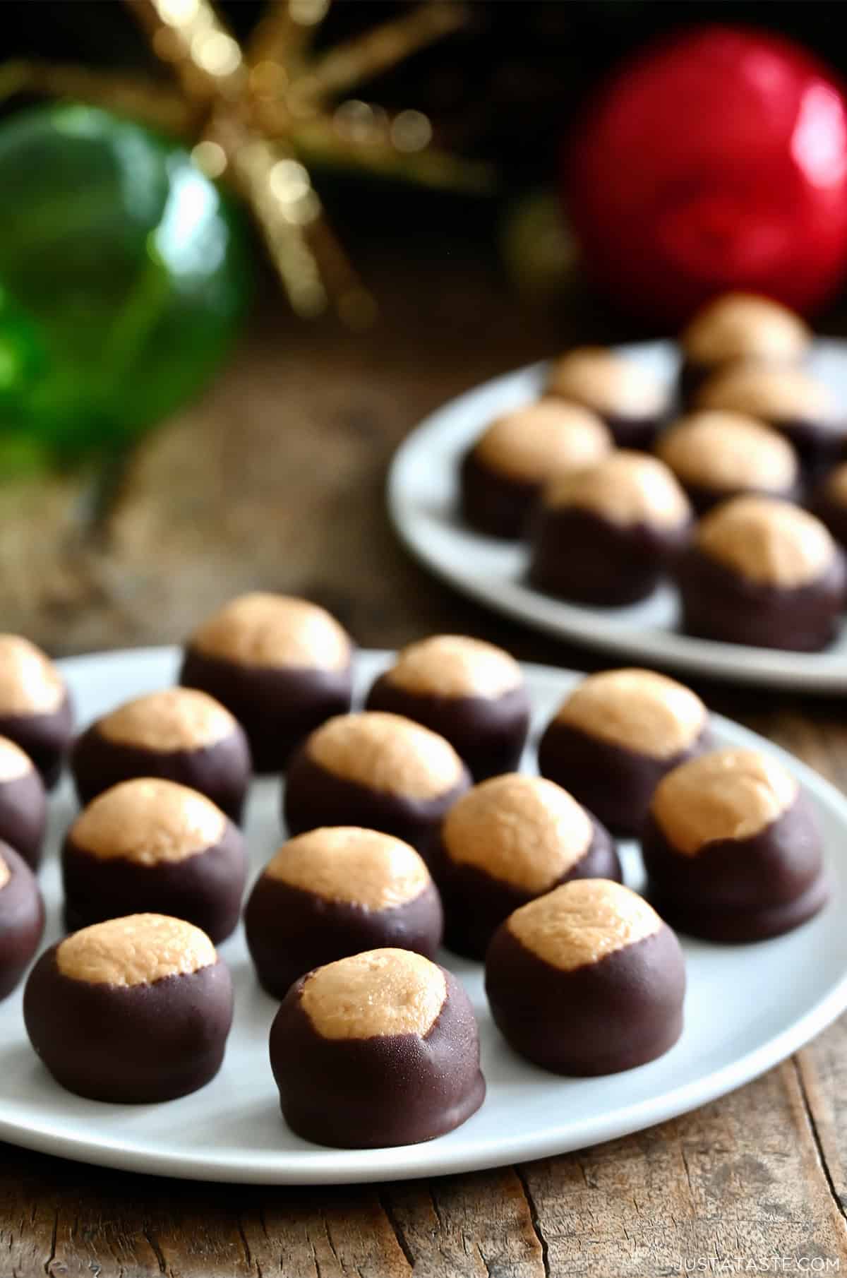 Buckeyes, also known as peanut butter balls coated with chocolate, on a serving plate.