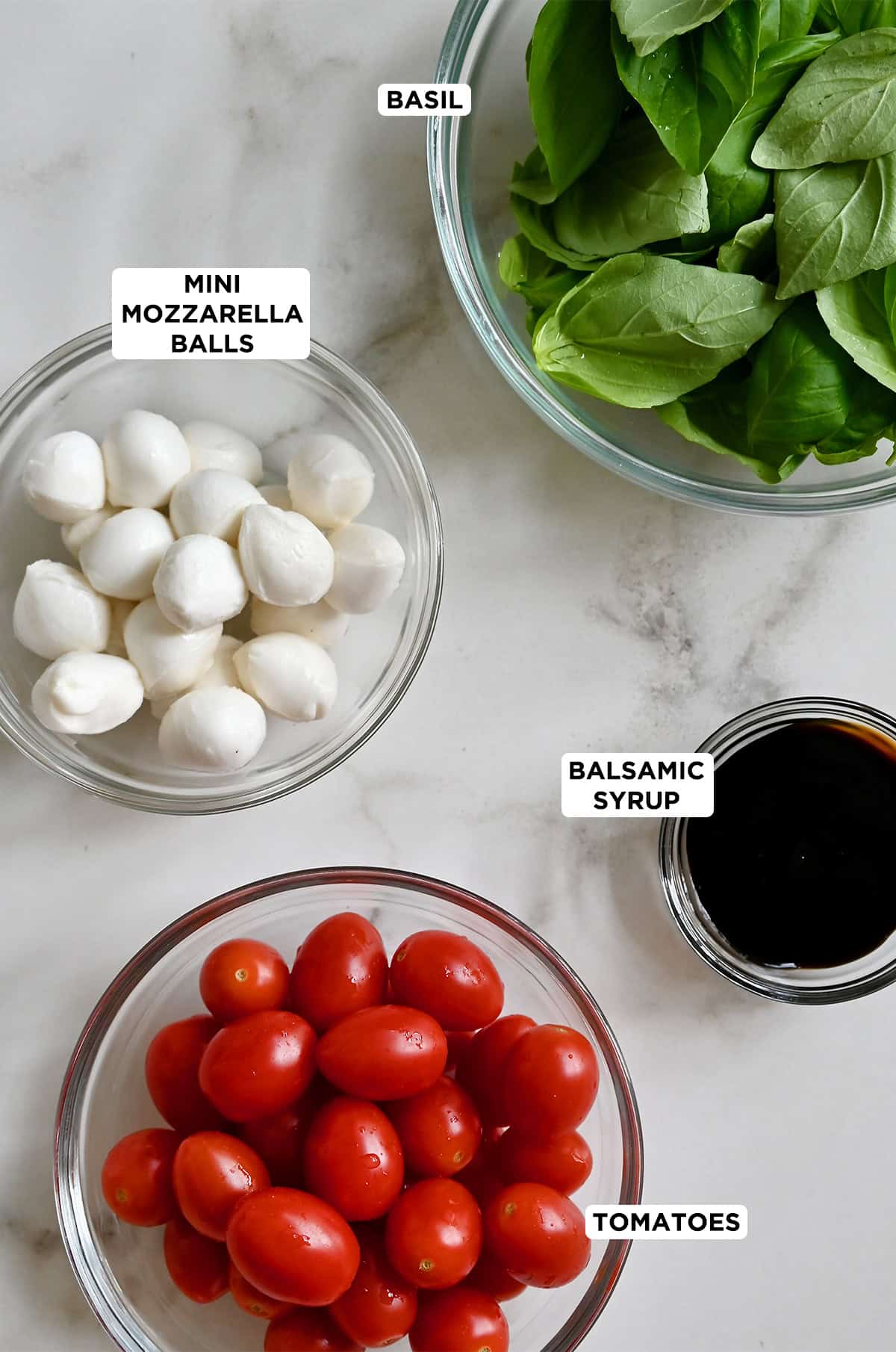 Ingredients for caprese skewers with balsamic glaze.