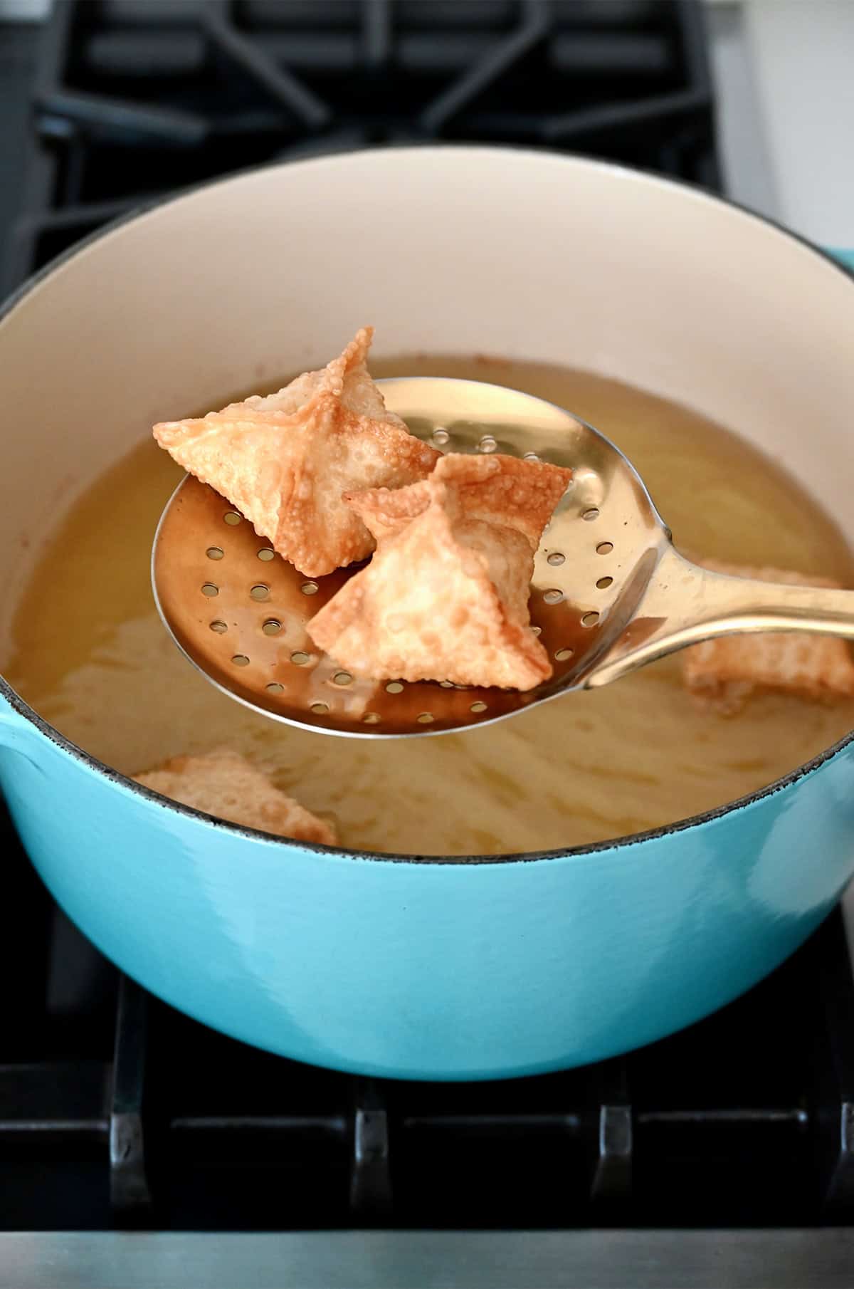 Frying crab rangoon in a heavy-bottomed stock pot.