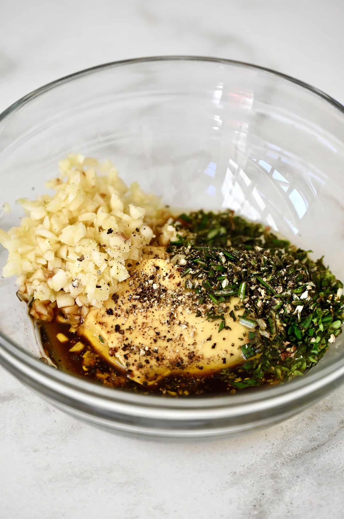 Wet rub for pork loin in a glass bowl.