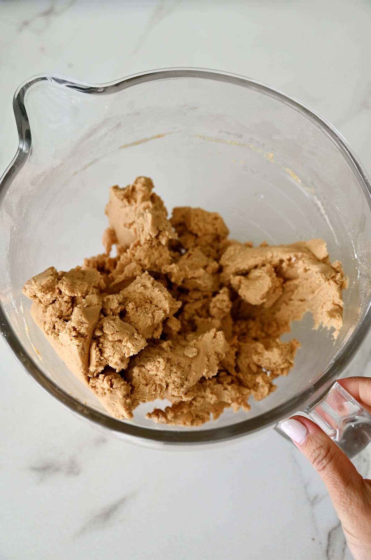 Peanut butter balls mixture in a glass bowl.