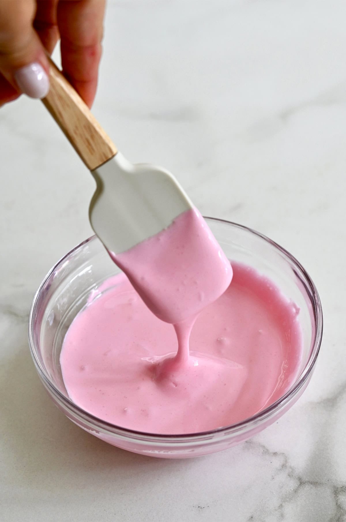 Pink royal icing in a bowl.