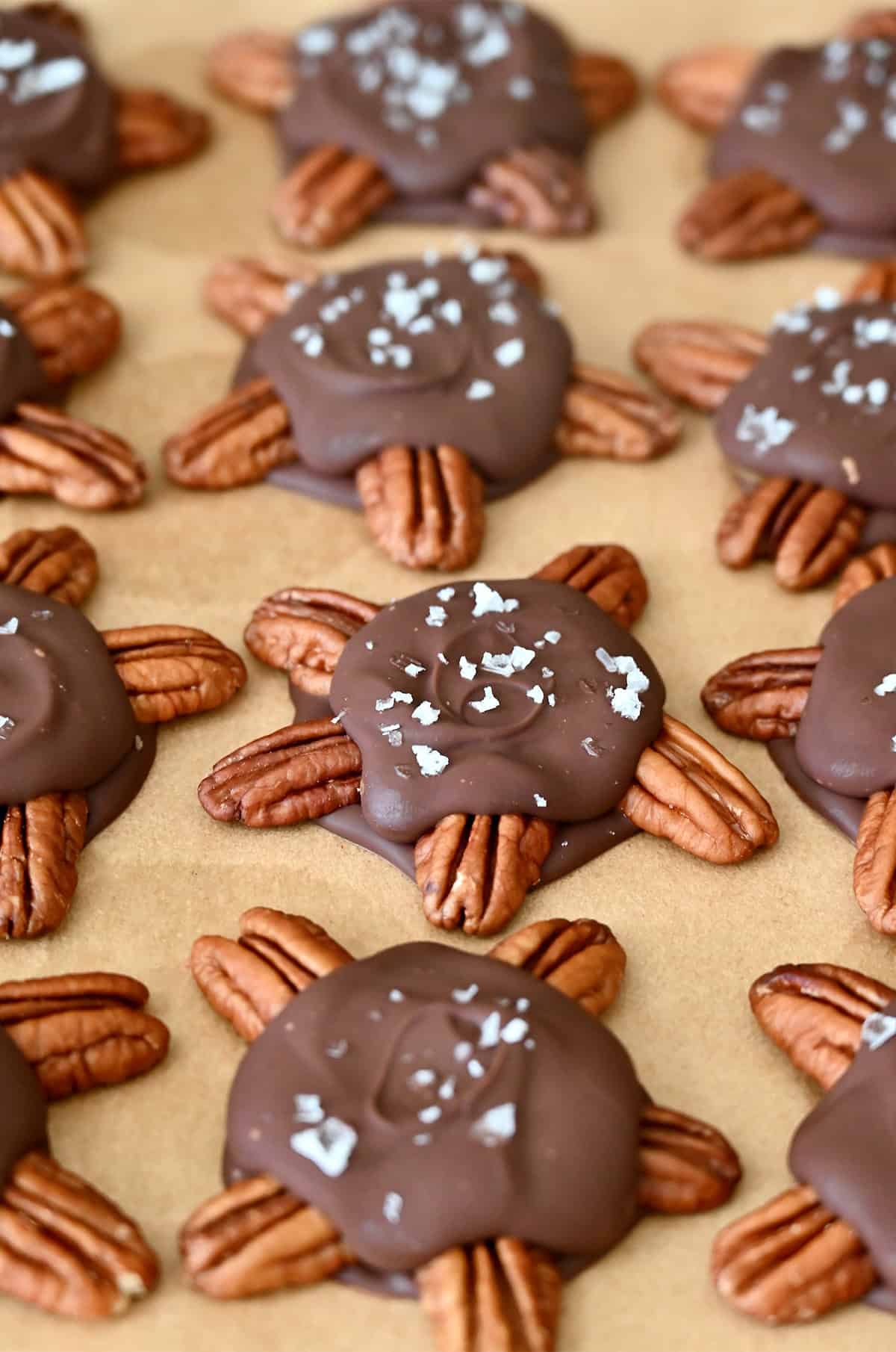 Homemade turtles candy topped with flaky sea salt.