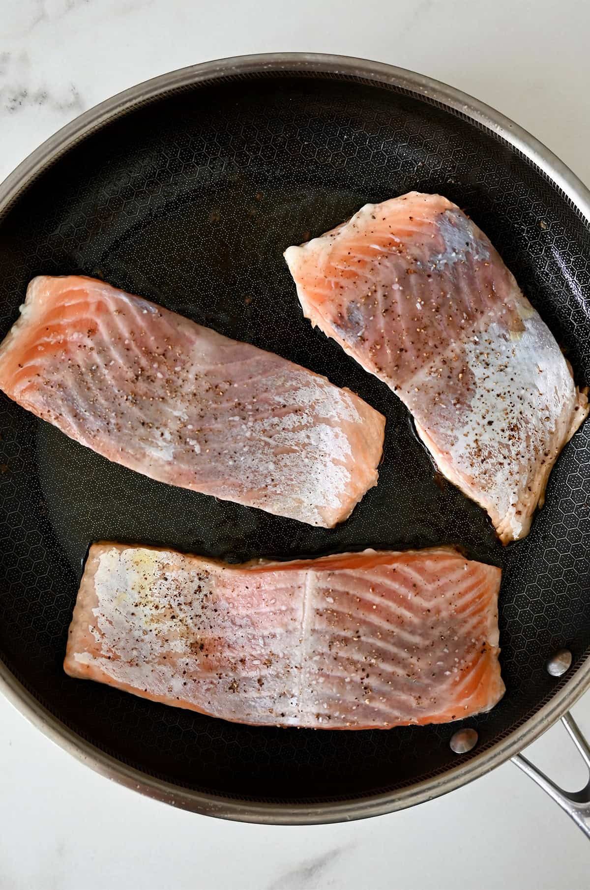 Cooking salmon in a skillet.