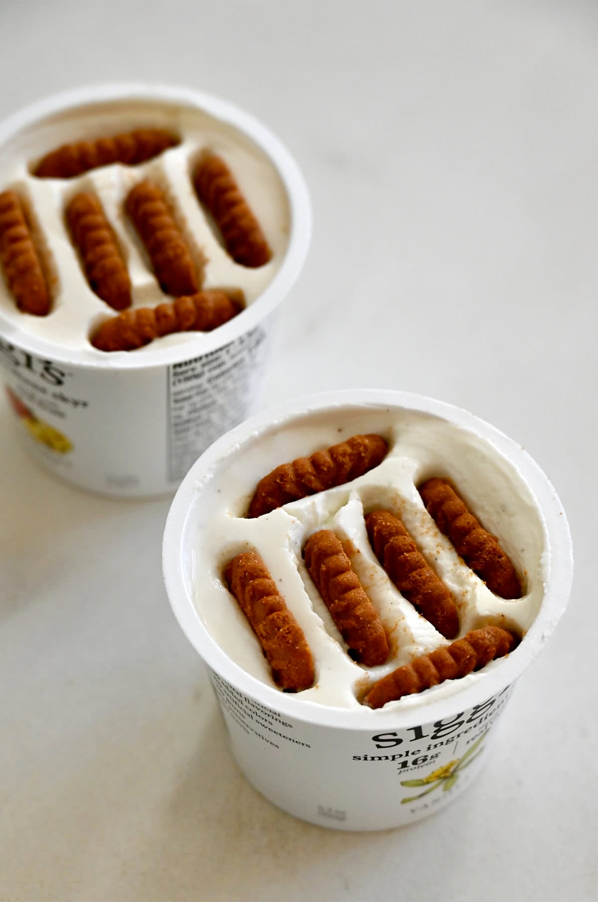 Chilled Japanese yogurt cheesecake made in a single-serving yogurt cup with Biscoff cookies.