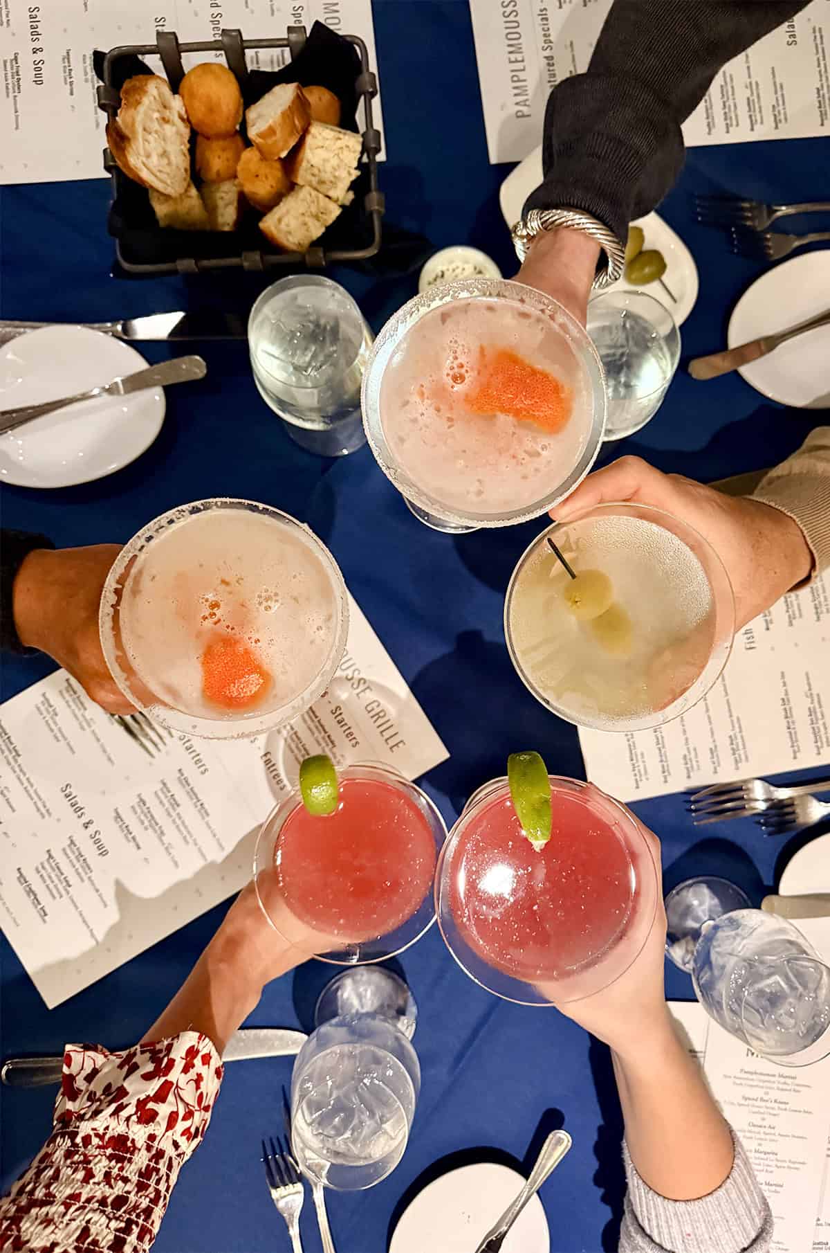 A top-down shot of cocktails at a dinner table