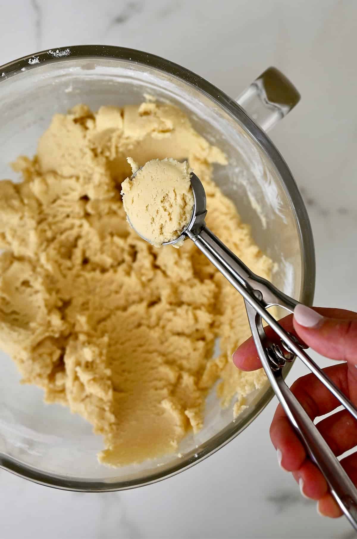 Scooped sugar cookie dough in a 2-tablespoon ice cream scoop.