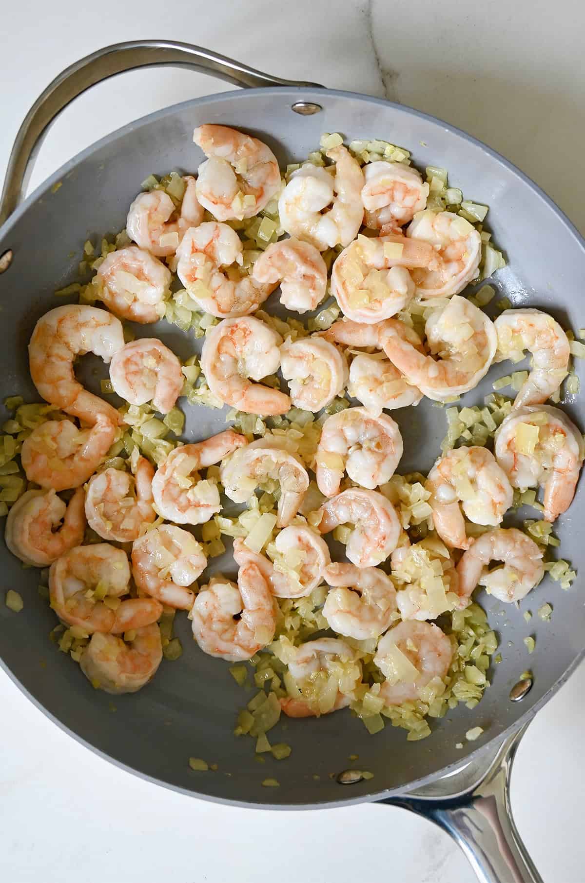 Cooked shrimp, onions, garlic and ginger in a large skillet.