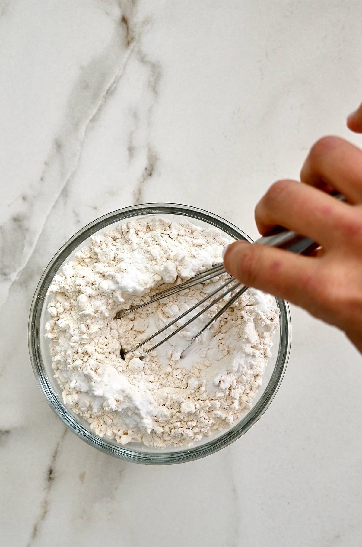 Whisking together flour, baking soda and salt in a small bowl.