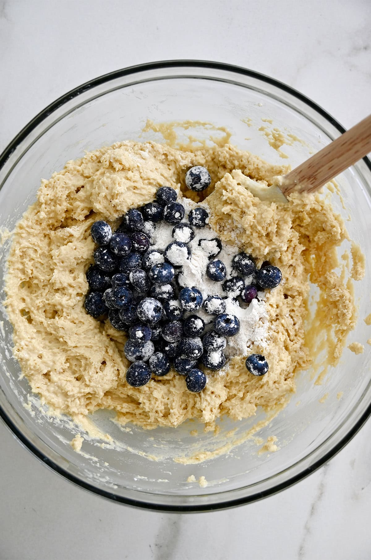 Folding blueberries into a cottage cheese muffin batter.
