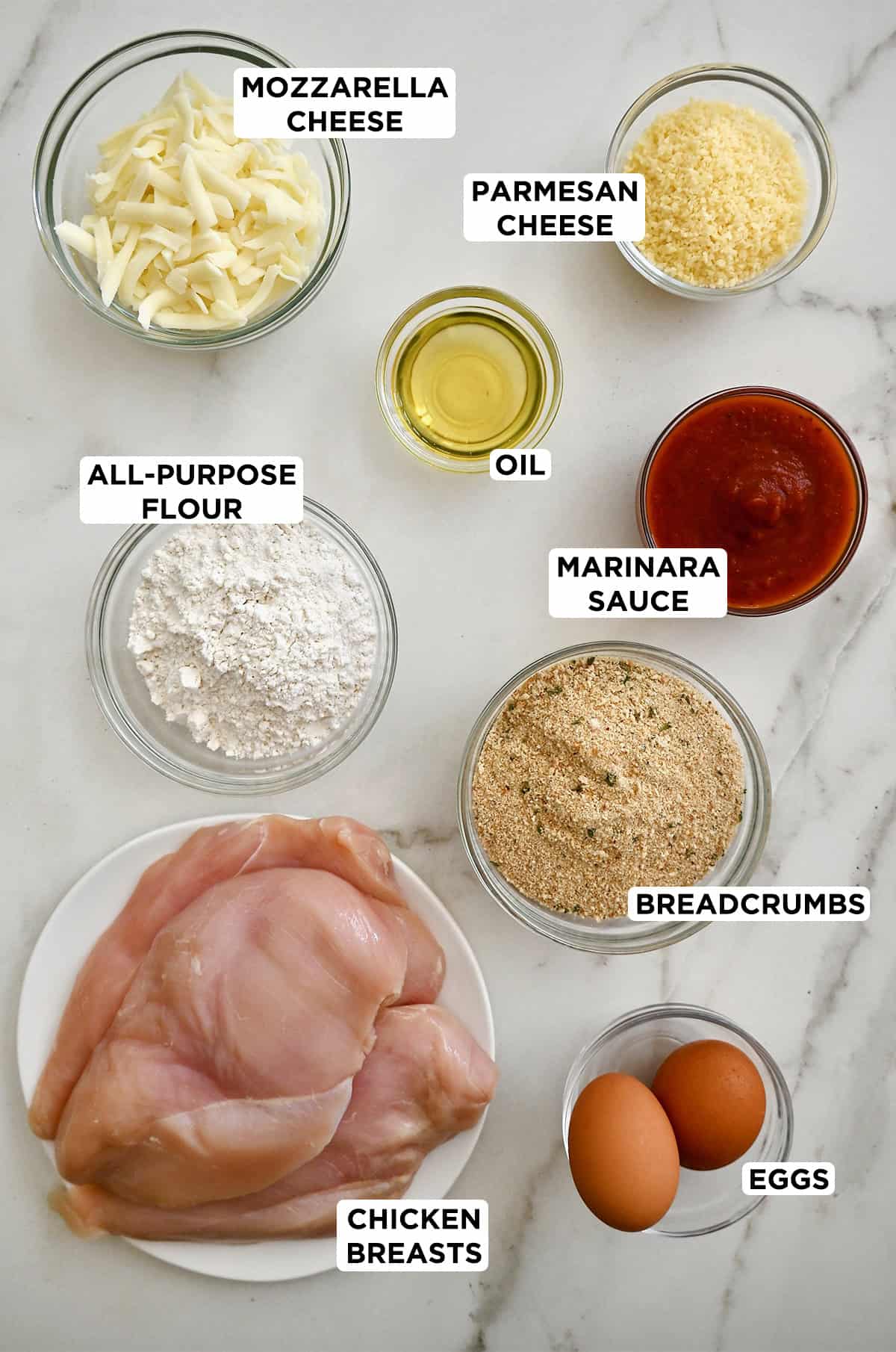 Ingredients needed to make chicken parmesan.
