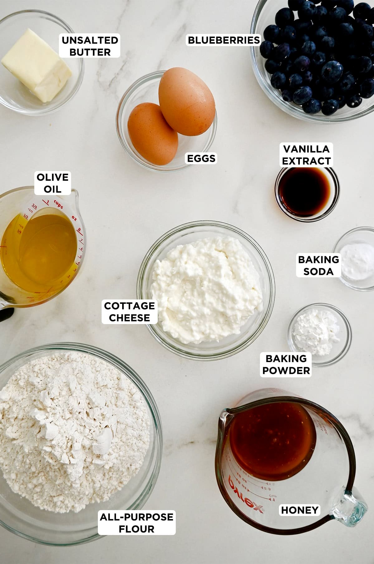 Ingredients to make blueberry protein muffins with cottage cheese and honey.
