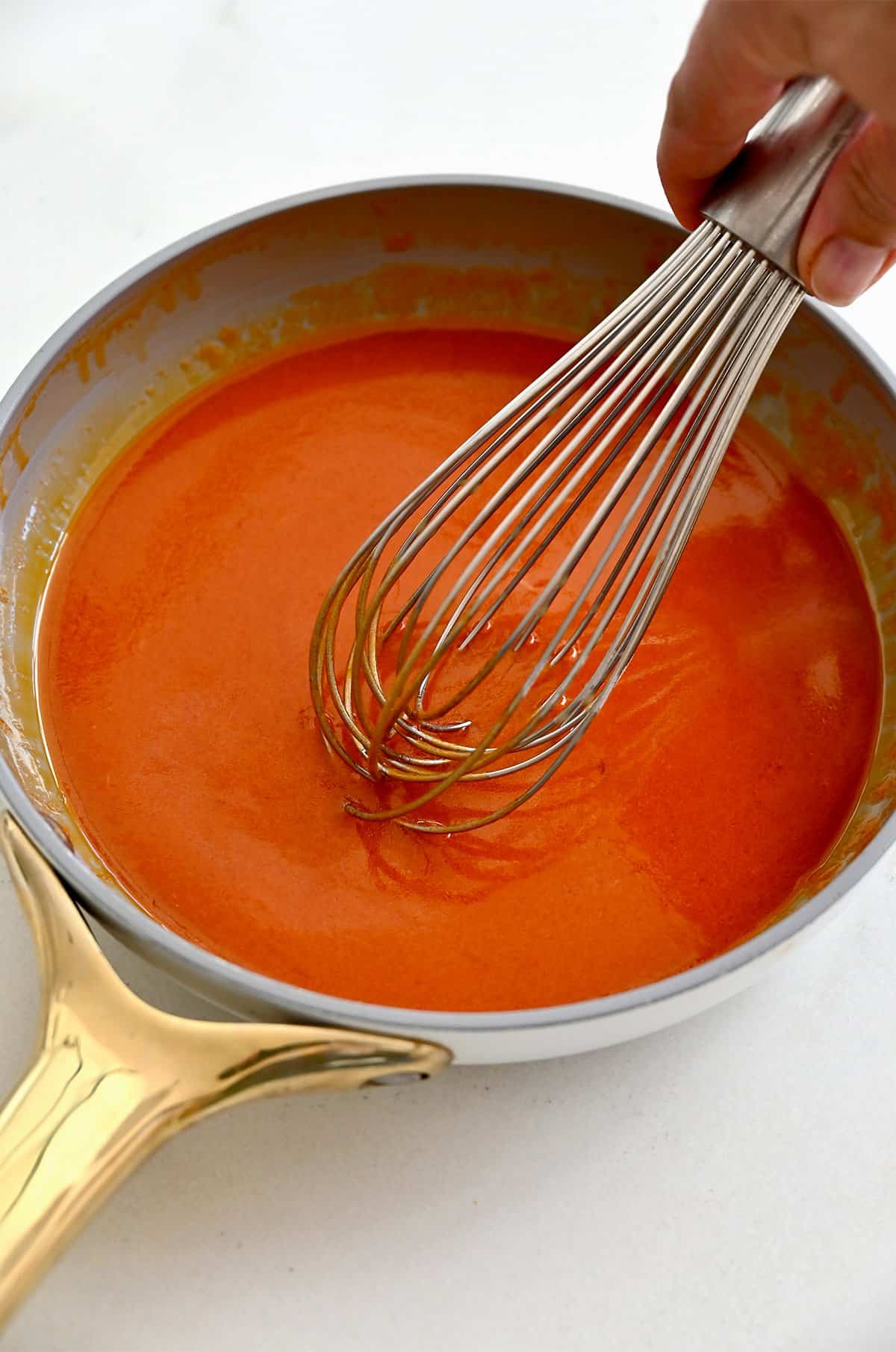Homemade Buffalo sauce in a saucepan.