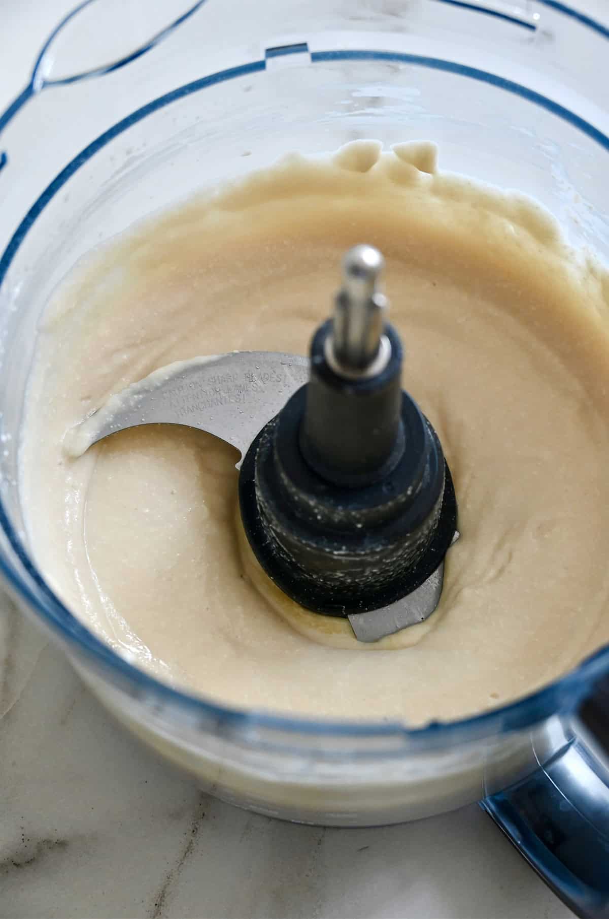 Smooth and creamy blended cottage cheese and honey in a food processor.