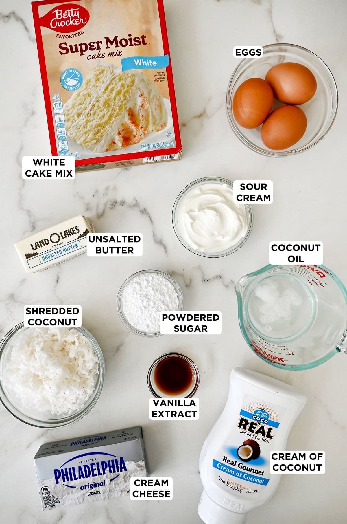 Ingredients to make a coconut cake using a box of white cake mix.