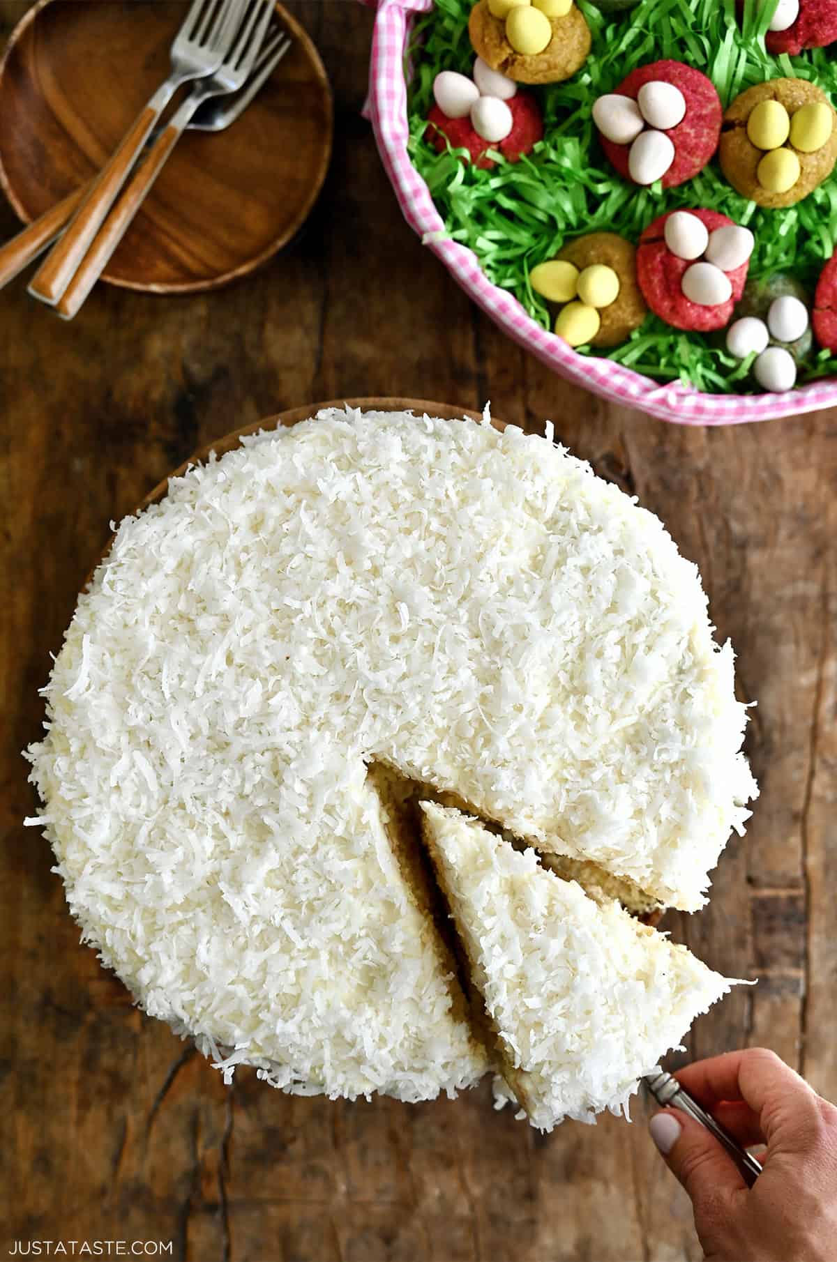 A coconut cake on a cake stand shot from overhead.