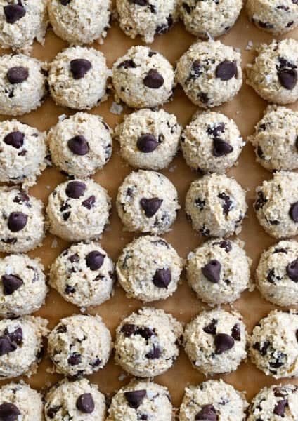 Perfect rows of chocolate chip cottage cheese cookie dough mounds on a baking sheet.