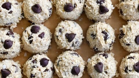 Perfect rows of chocolate chip cottage cheese cookie dough mounds on a baking sheet.