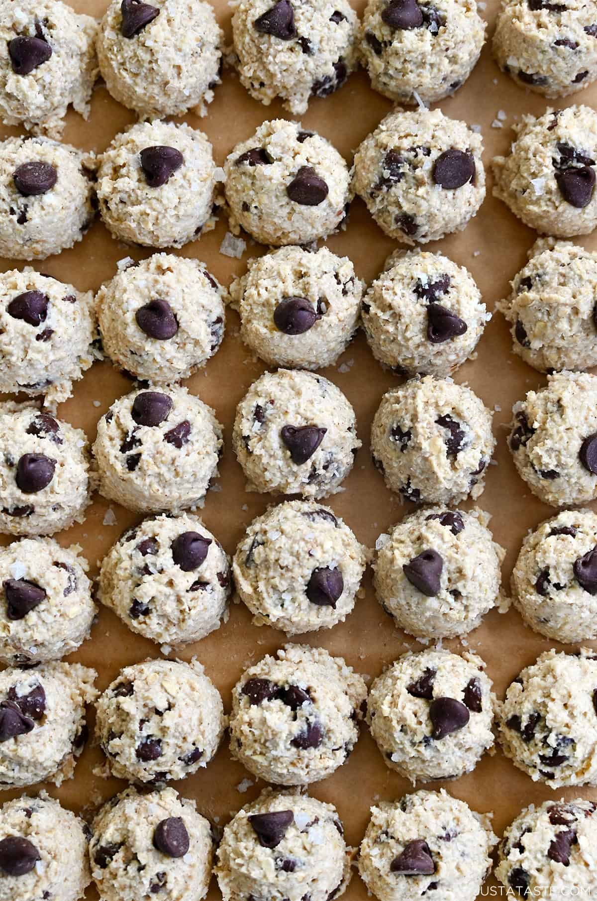 Perfect rows of chocolate chip cottage cheese cookie dough mounds on a baking sheet.