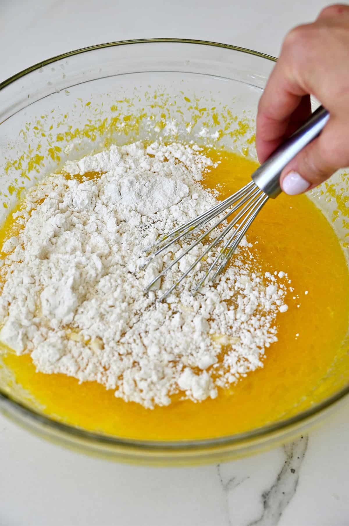 Whisking the ingredients together to make a lemon filling for bars.