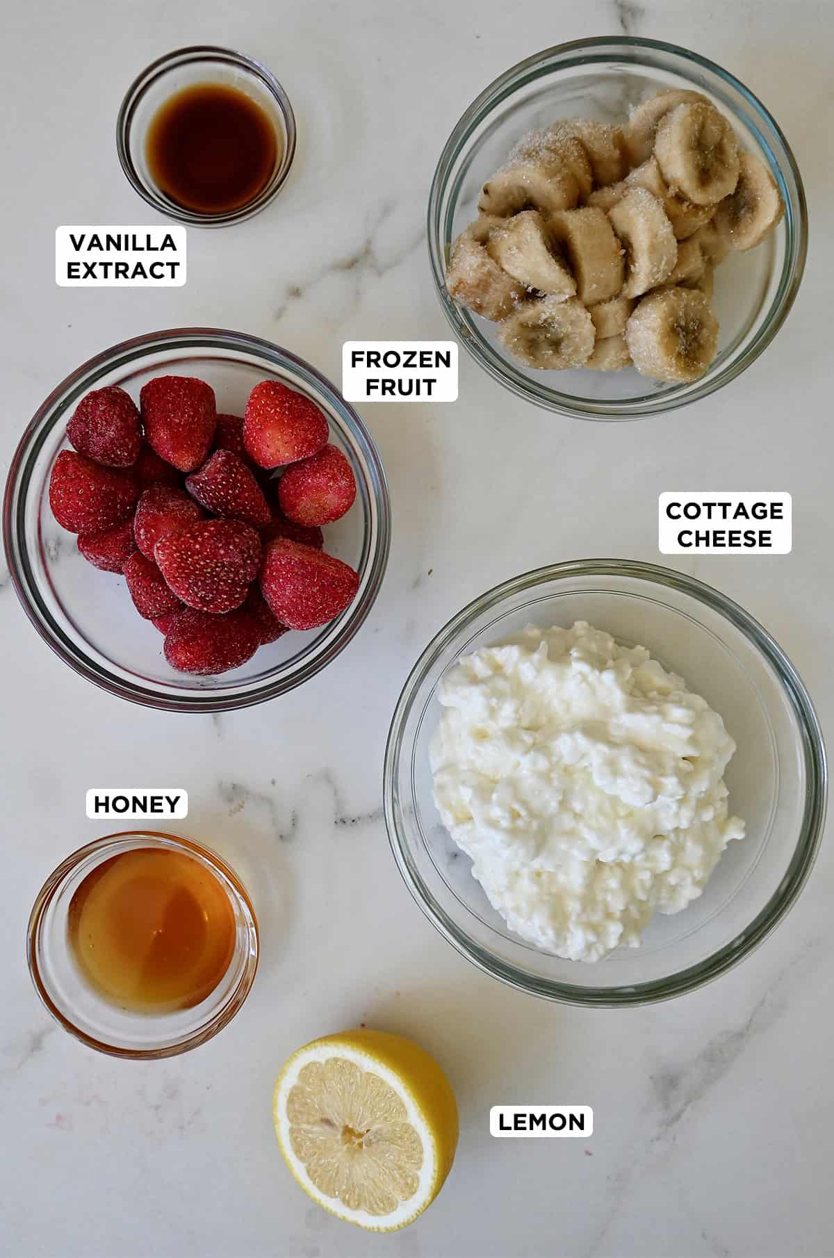 Ingredients to make cottage cheese ice cream in various sizes of glass bowls.