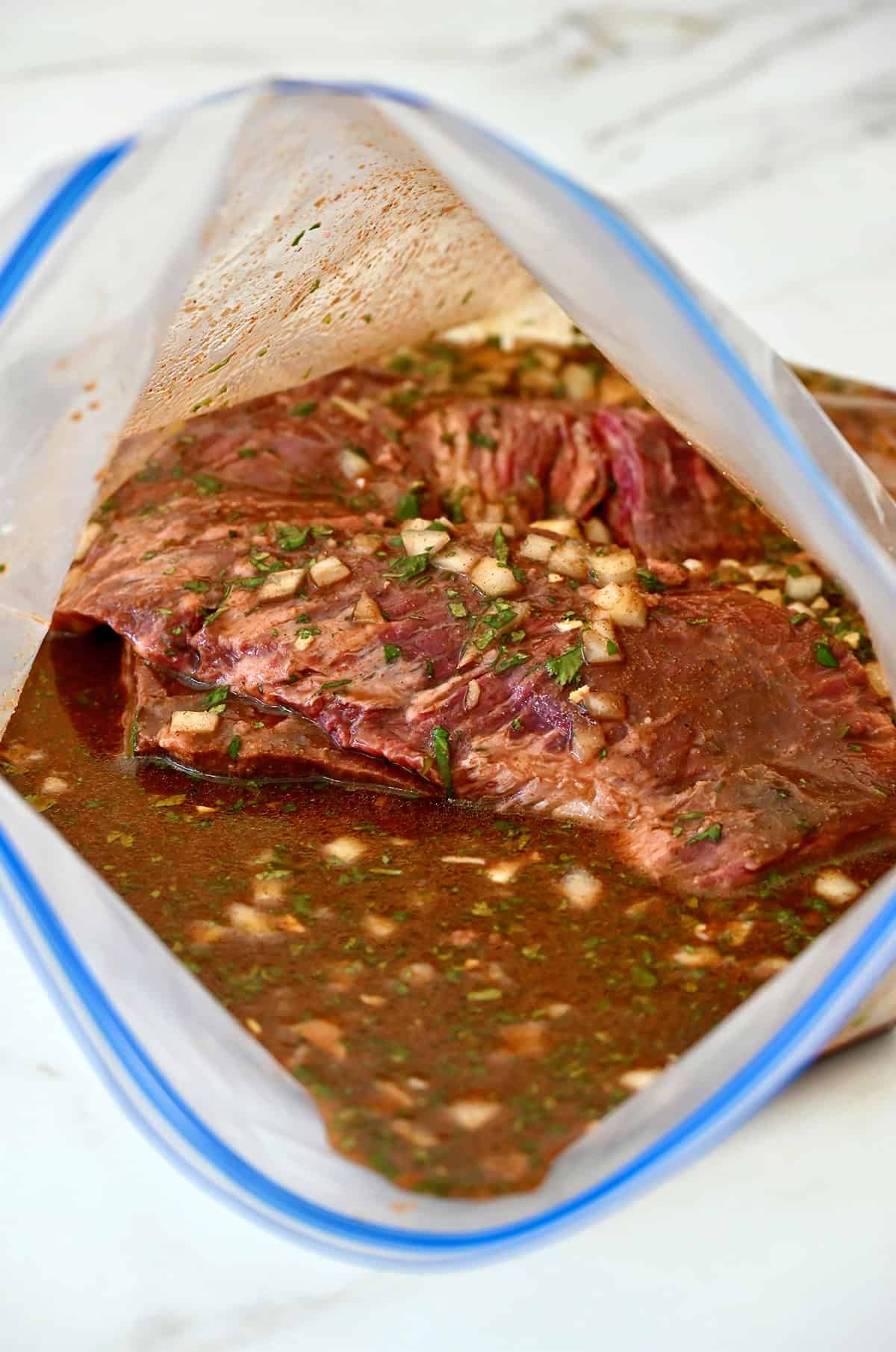 Marinated carne asada in a large ziplock bag.