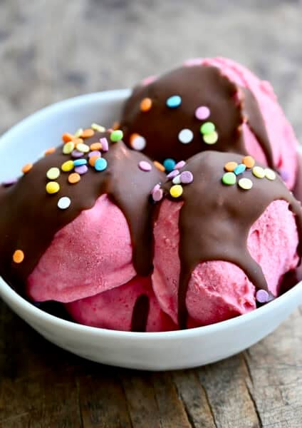 Strawberry cottage cheese ice cream with a magic shell topping and sprinkles.