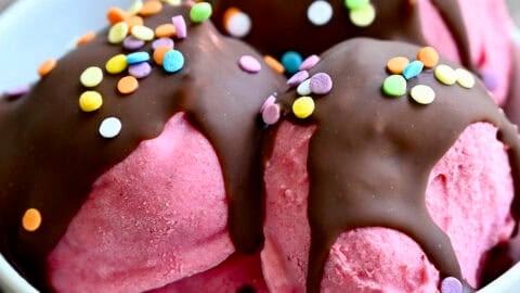 Strawberry cottage cheese ice cream with a magic shell topping and sprinkles.