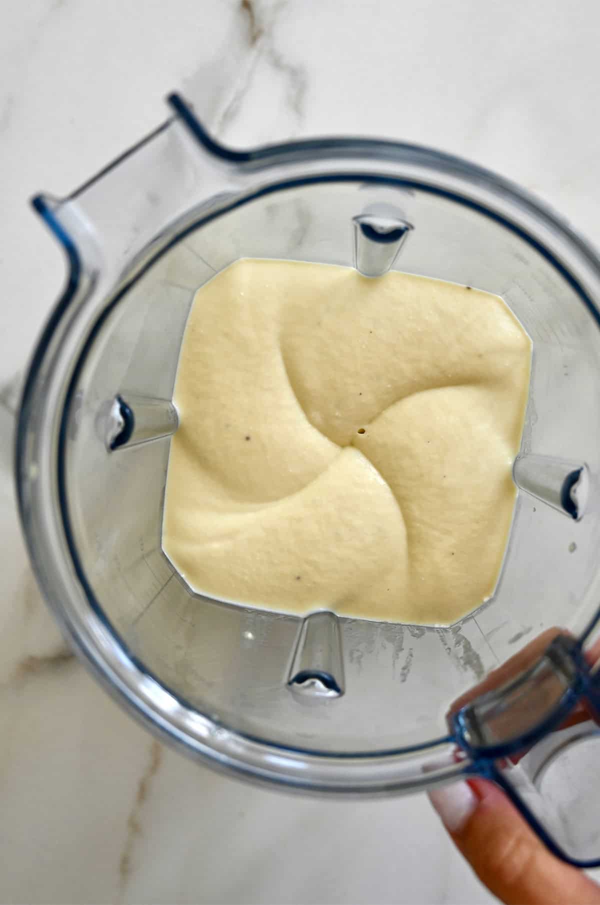 Wet ingredients for banana bread blended until thick and smooth.