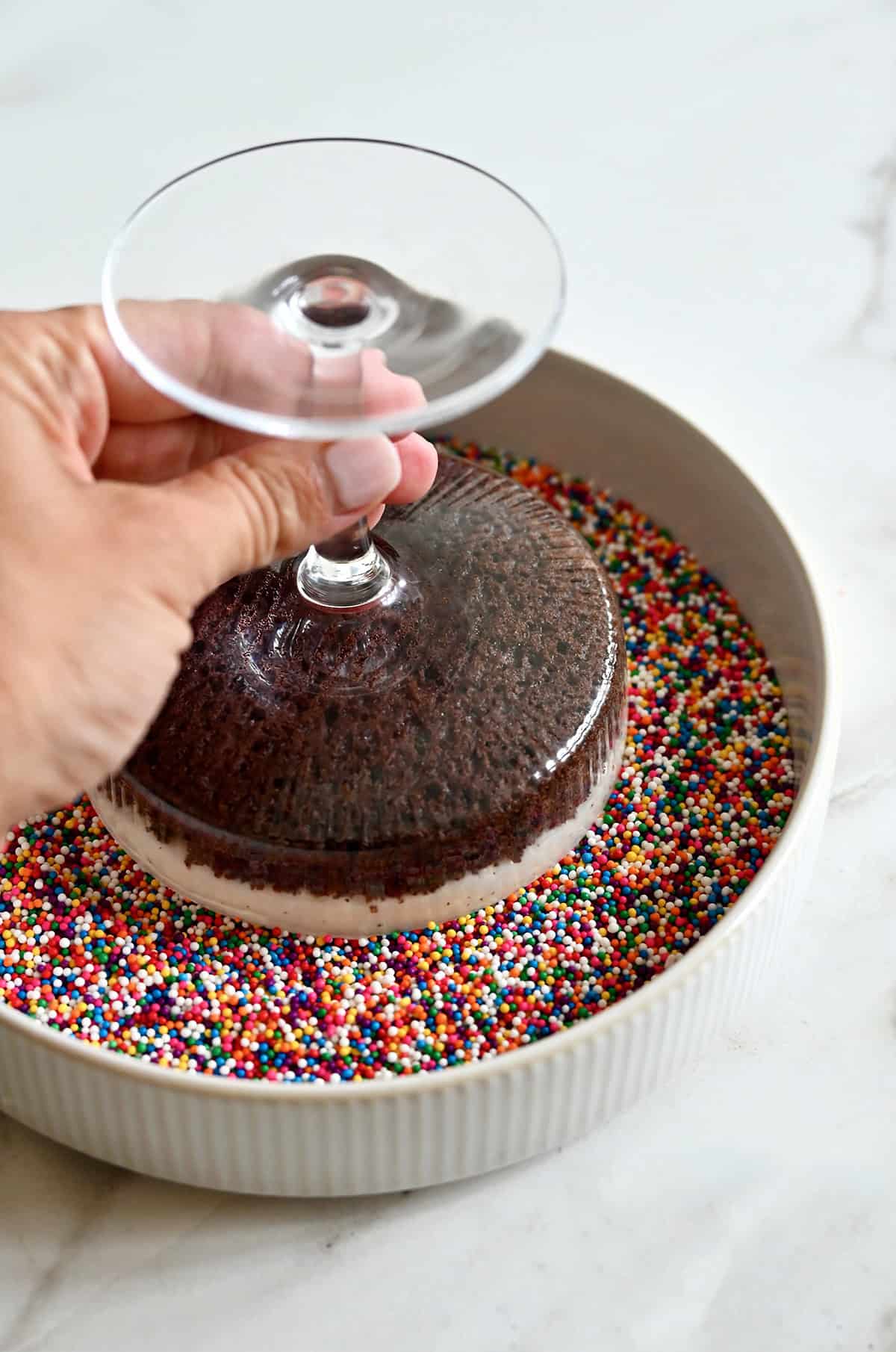 Invert a cocktail cake onto nonpareil sprinkles to adhere to the frosting.