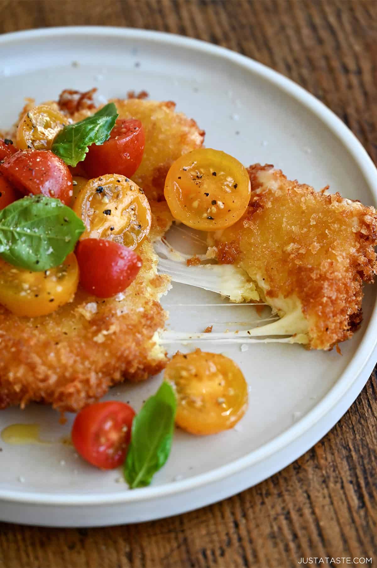Gooey fried mozzarella topped with a cherry tomato and basil salad.