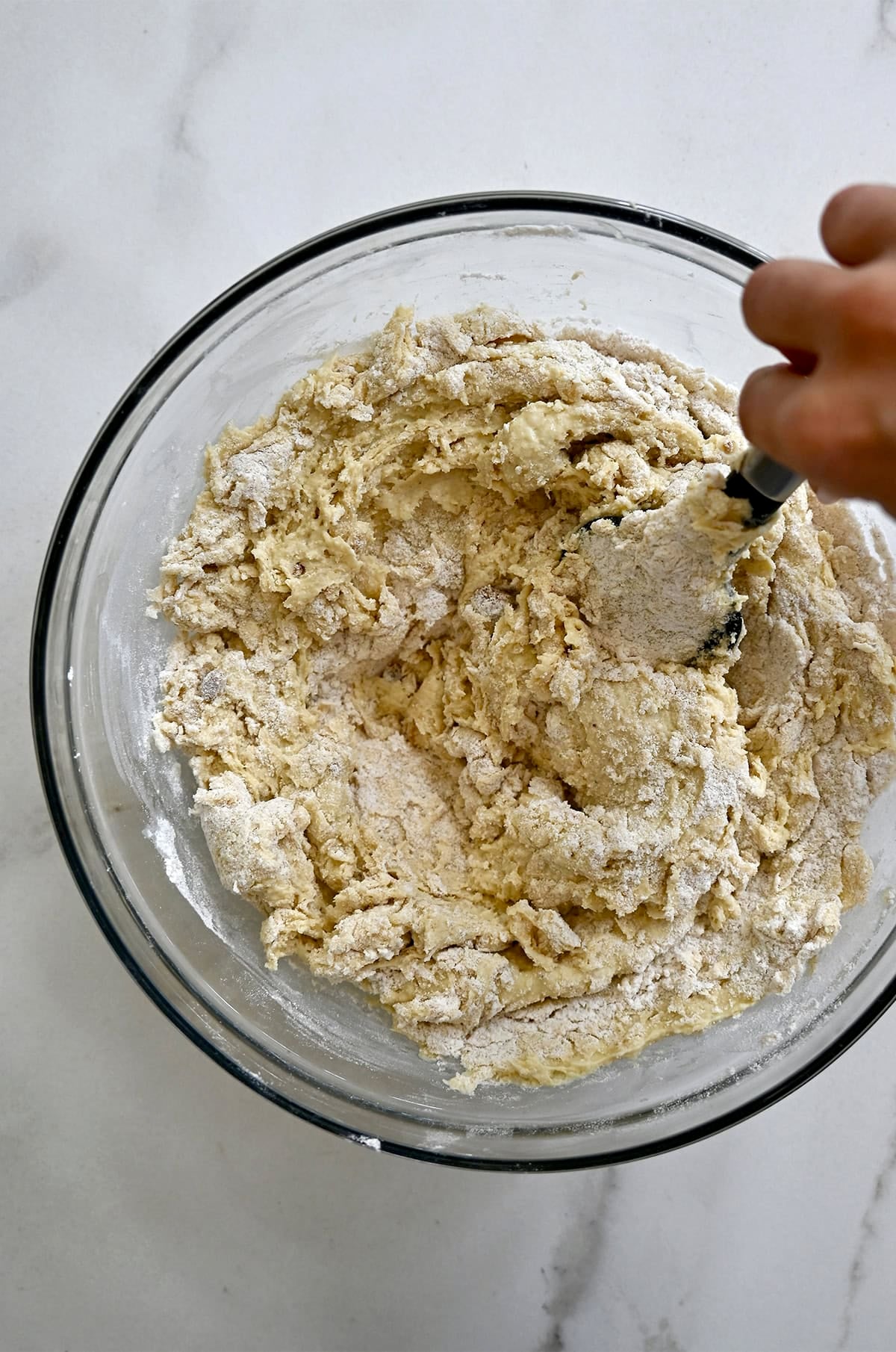 A thick cottage cheese banana bread batter in a large glass bowl.