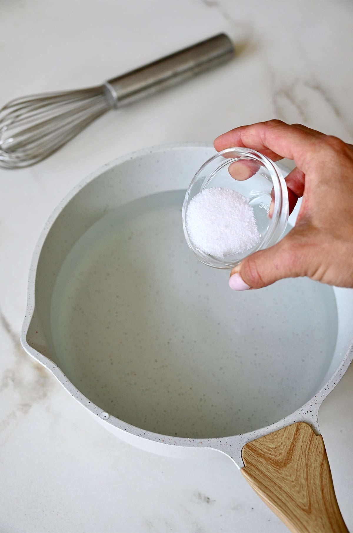 Salting water to poach chicken.