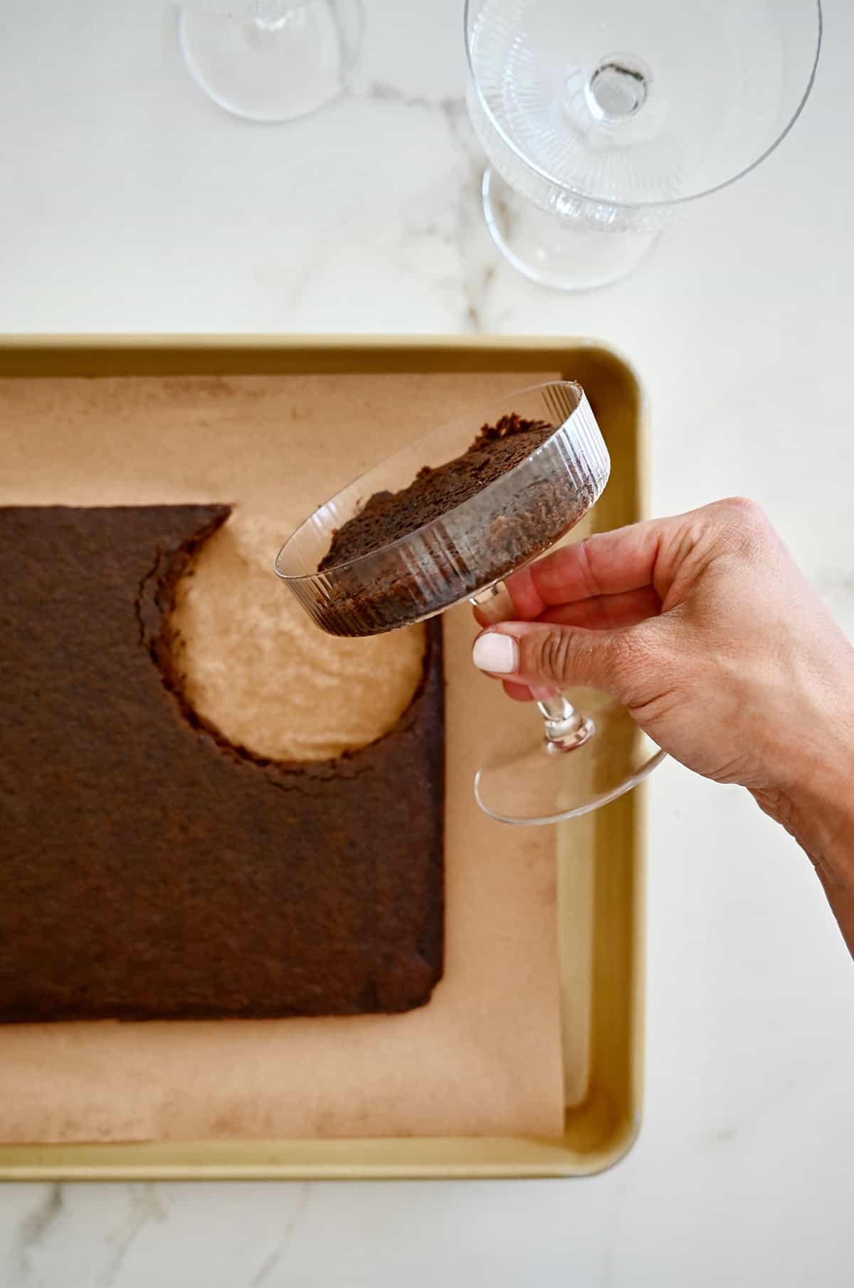 Stamping out chocolate cake with a cocktail glass.